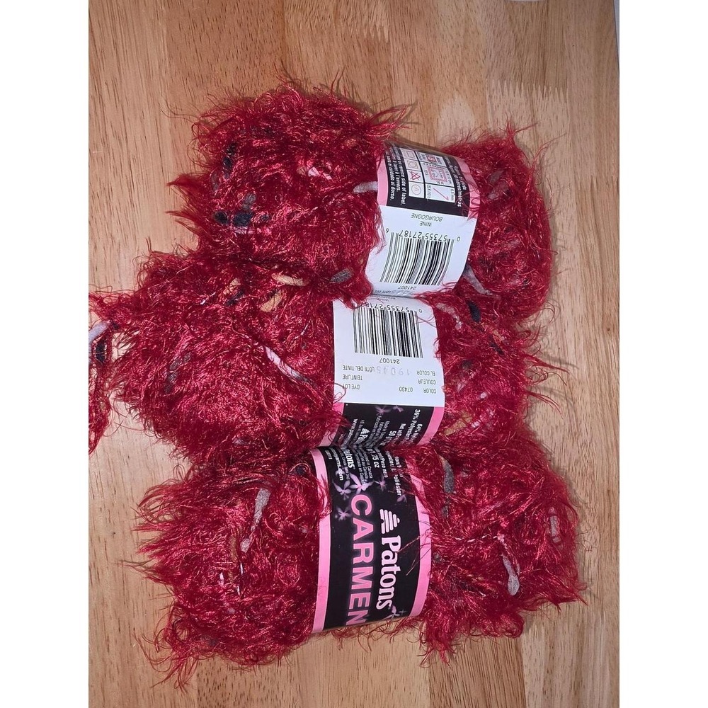 three skeins of Patons Carmen Yarn in the color Wine (Color code: 7430 / 241007)